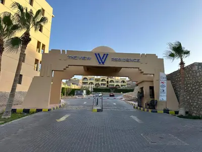 a building with a sign that reads the new v residence at The Hill House in Hurghada