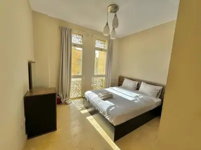 a bedroom with a bed and a large window at One bedroom Mangroovy El Gouna in Hurghada