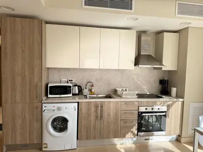a kitchen with a washing machine and a microwave at One bedroom Mangroovy El Gouna in Hurghada