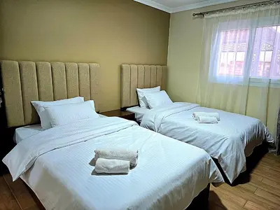 a bedroom with two beds with towels on them at Elnahla Villa in Hurghada