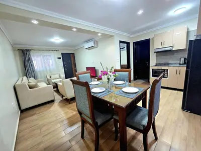 a kitchen and living room with a table and chairs at Elnahla Villa in Hurghada