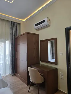 a room with a desk and a dresser and a bedroom at Elnahla Villa in Hurghada