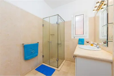 a bathroom with a shower and a sink at Townhouse with roof terrace,balcony and large pool in Hurghada