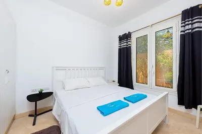 a bedroom with a bed with blue trays on it at Townhouse with roof terrace,balcony and large pool in Hurghada
