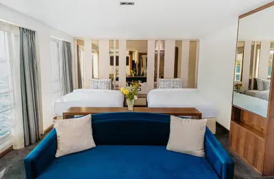 a living room with a blue couch and two beds at Savoy Yacht - Exclusive Nile Cruise from Luxor to Aswan in Luxor