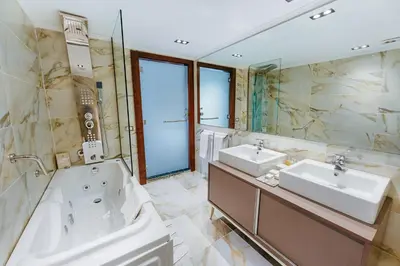 a large bathroom with two sinks and a tub at Savoy Yacht - Exclusive Nile Cruise from Luxor to Aswan in Luxor