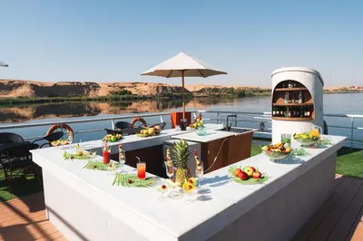 a table with food on top of a boat at Savoy Yacht - Exclusive Nile Cruise from Luxor to Aswan in Luxor