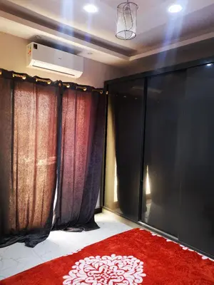 a room with black and red curtains and a red rug at I&A studia in Hurghada