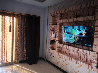 a living room with a tv on a brick wall at I&A studia in Hurghada