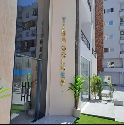 a building with a sign on the side of it at Sami and Sam studio apartment in Hurghada