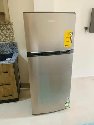 a stainless steel refrigerator sitting in a kitchen at Sami and Sam studio apartment in Hurghada