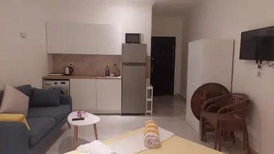 a living room with a couch and a kitchen at Hurghada Concierge at Fiesta Beach Resort 411 in Hurghada