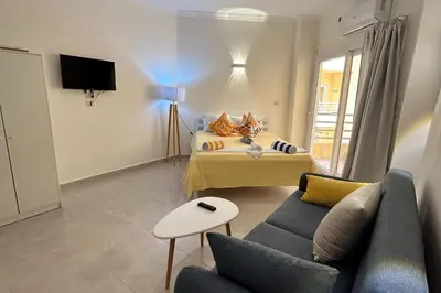 a living room with a bed and a couch at Hurghada Concierge at Fiesta Beach Resort 411 in Hurghada