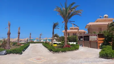 a resort with palm trees and a building at Hurghada Concierge at Fiesta Beach Resort 411 in Hurghada