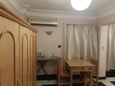 a room with a table and a table and a table and a window at fayrouz apartment in Jazīrat al ‘Awwāmīyah