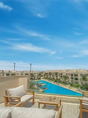 a view of a pool from the balcony of a apartment at Cozy One Bedroom in Mangroovy in Hurghada