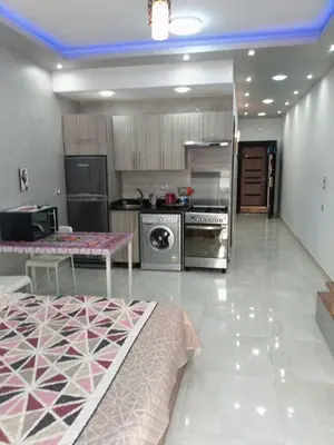 a large kitchen with stainless steel appliances and a table at Compound El makramia 504 in Hurghada