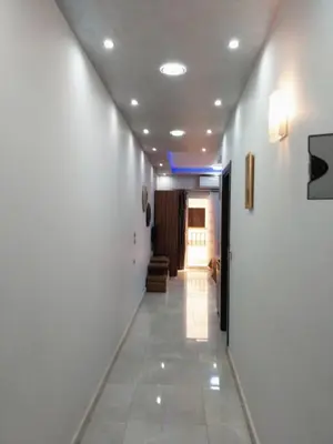 a hallway with white walls and a hallway with a hallway at Compound El makramia 504 in Hurghada