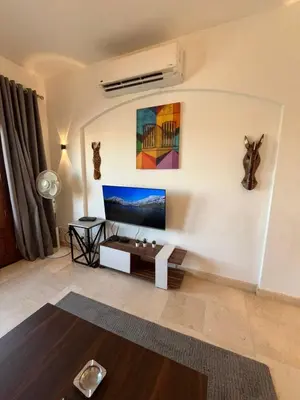 a living room with a tv on the wall at El Gouna Sabina Y160 in Hurghada