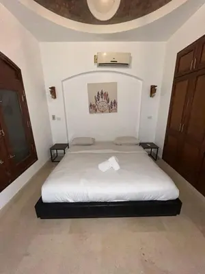 a bedroom with a bed with a white sheets at El Gouna Sabina Y160 in Hurghada