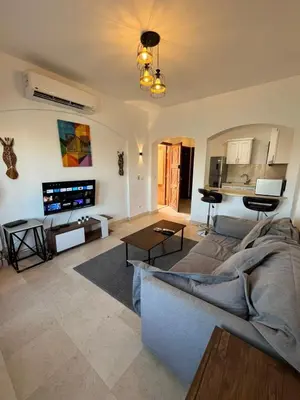 a living room with a couch and a tv at El Gouna Sabina Y160 in Hurghada