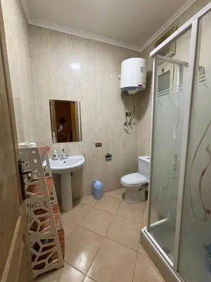 a bathroom with a shower and a toilet and a sink at Stefy Holiday Hurghada in Hurghada