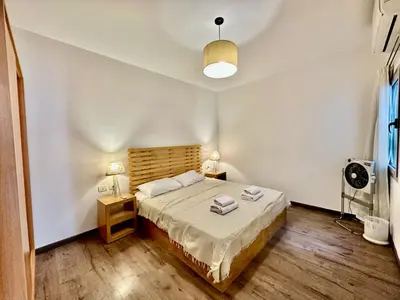 a bedroom with a bed and two lamps and a fan at Cozy 2 bedroom Sholan 1 - Gouna in Hurghada