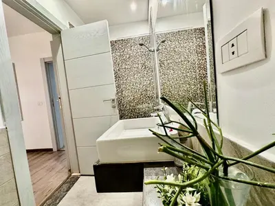 a bathroom with a shower and a tub and a plant at Cozy 2 bedroom Sholan 1 - Gouna in Hurghada