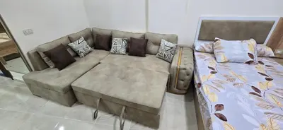 a couch with pillows on it in a living room at Tiba Golden Resort Hurghada in Hurghada