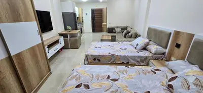 a living room with two beds and a tv at Tiba Golden Resort Hurghada in Hurghada