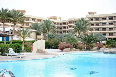 a large swimming pool in front of a large building at Palma Resort Hurghada in Hurghada