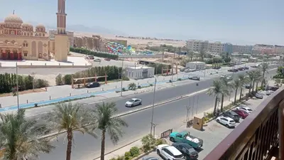 a city street with cars parked on the side of a road at Palma Resort Hurghada in Hurghada