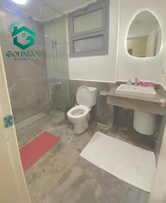 a bathroom with a toilet and a sink at Cozy studio in Bali in Hurghada
