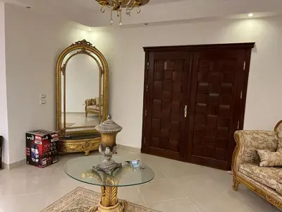 a living room with a glass table and a mirror at فيلا للإيجار فى مجاويش الغردقة in Hurghada
