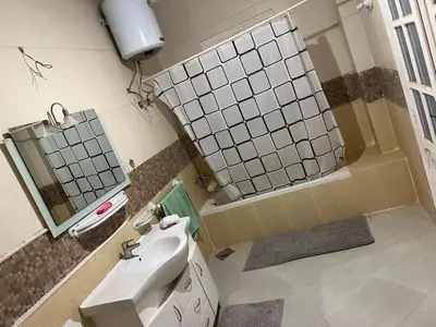 a bathroom with a sink and a mirror at فيلا للإيجار فى مجاويش الغردقة in Hurghada