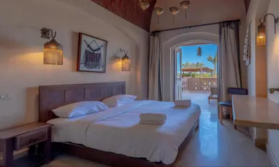 a bedroom with a large bed and a balcony at Luxury Stays in West Golf El Gouna in Hurghada