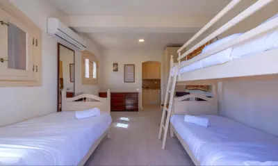 a bedroom with two bunk beds and a kitchen at Luxury Stays in West Golf El Gouna in Hurghada