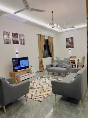 a living room with couches and a flat screen tv at Villa Kayan in Luxor