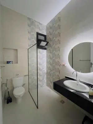 a bathroom with a toilet and a sink and a mirror at Villa Kayan in Luxor