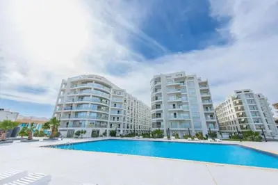 a swimming pool in front of two apartment buildings at سكانديك ريزورت in Hurghada