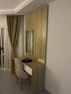 a desk in a room with a chair and a mirror at سكانديك ريزورت in Hurghada
