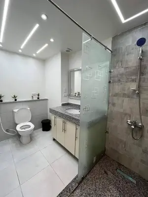 a bathroom with a toilet and a glass shower stall at سكانديك ريزورت in Hurghada