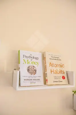 two books sitting on top of a shelf at Ladybird - Veranda Nest in Hurghada