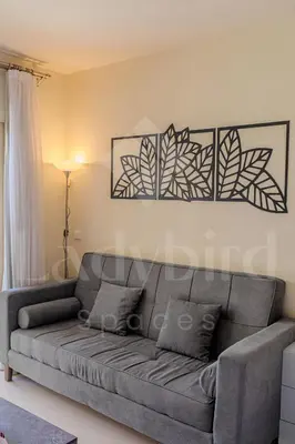 a living room with a gray couch in a room at Ladybird - Veranda Nest in Hurghada