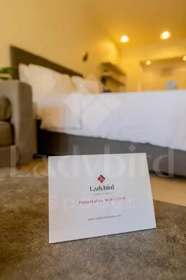 a sign on the floor of a hotel room with a bed at Ladybird - Veranda Nest in Hurghada