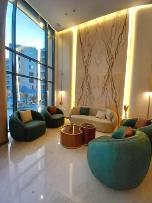 a living room with couches and chairs in a building at Sam and Sami studio apartment in Hurghada