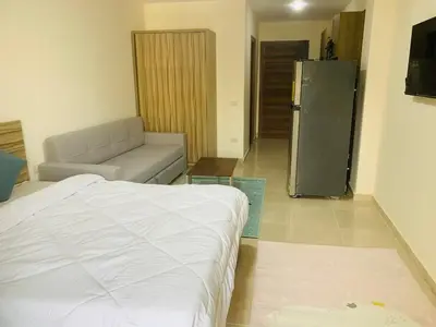 a living room with a bed and a couch at Sam and Sami studio apartment in Hurghada
