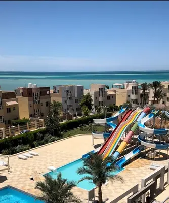 a pool with a water slide at a resort at Fanadir L406 in Hurghada