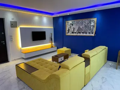 a living room with a couch and a tv at Fanadir L406 in Hurghada