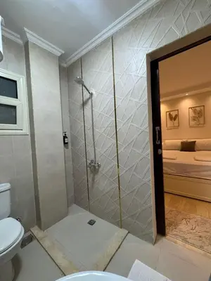 a bathroom with a shower and a toilet at Avin Resort Hurghada in Hurghada